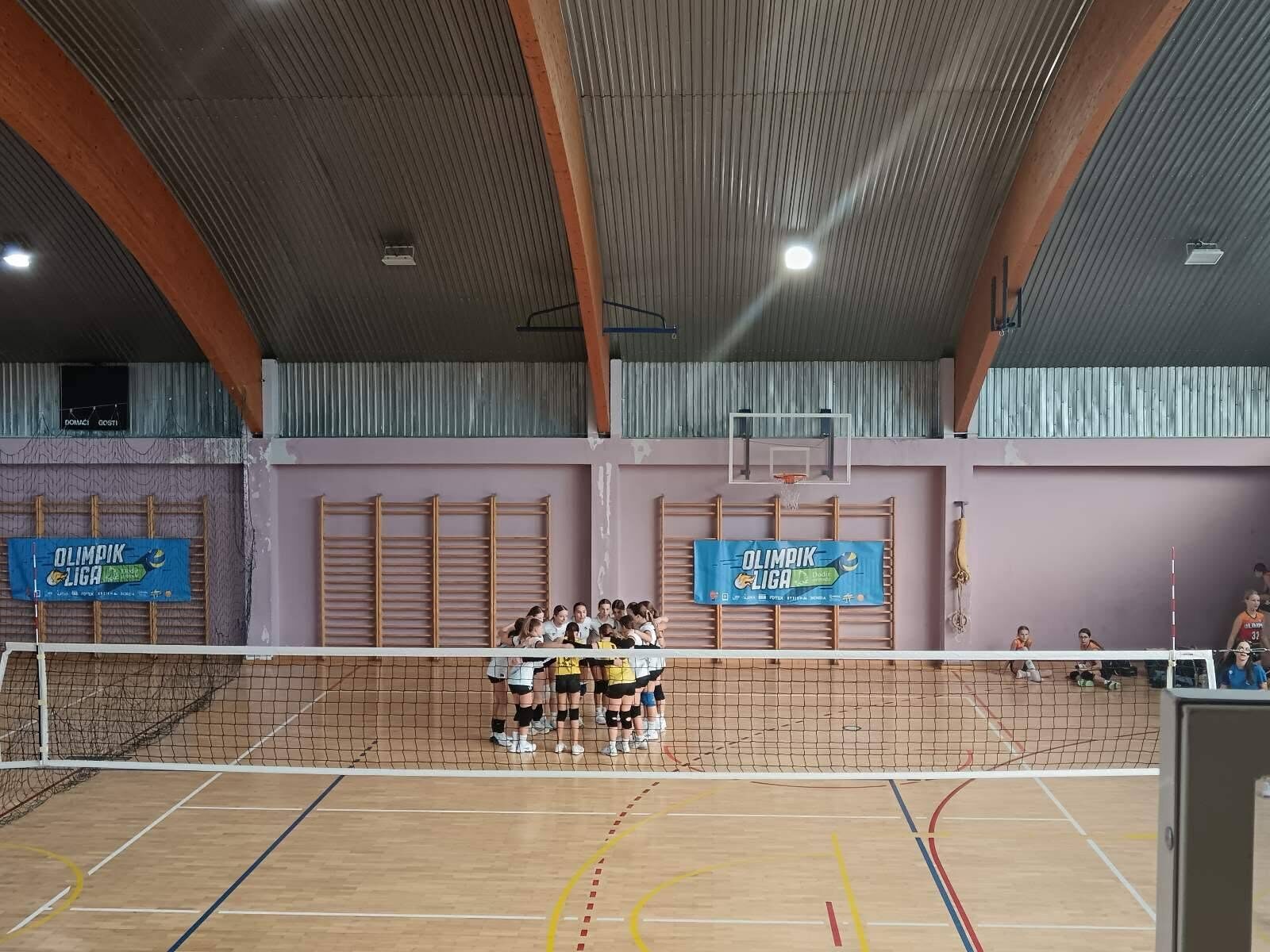 Players forming a team huddle on the court